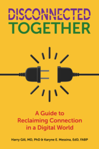 Book cover titled “Disconnected Together.” The words “Disconnected” (in purple) and “Together” (in green) appear at the top against a yellow background. Below them, two black electrical plugs face each other but do not connect, with radiating lines suggesting tension. The subtitle reads “A Guide to Reclaiming Connection in a Digital World.” Authors listed at the bottom: Harry Gill, MD, PhD, and Karyne E. Messina, EdD, FABP.